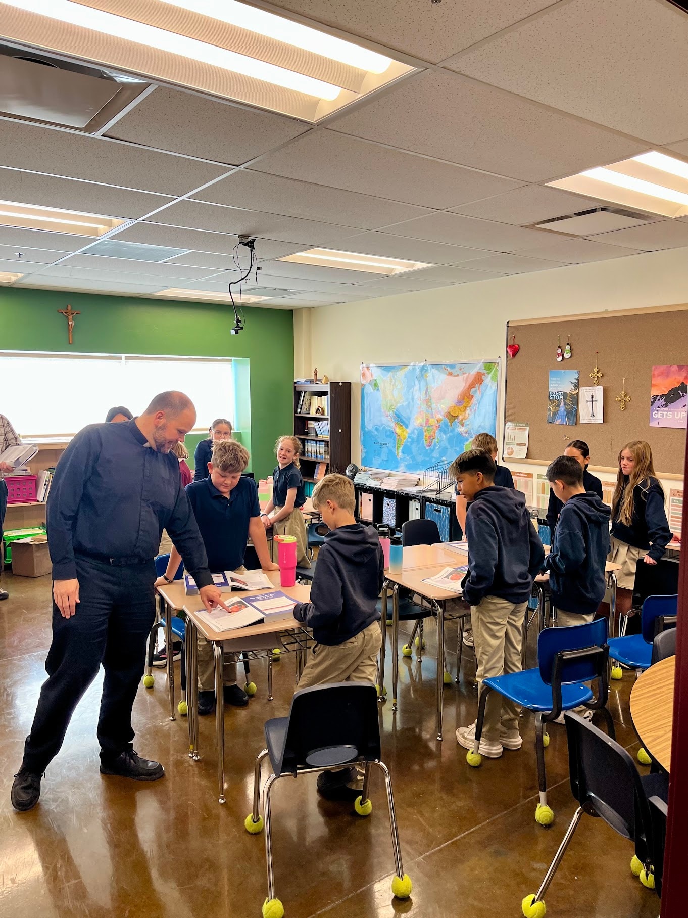 Fr. Matthew visiting a classroom at Pope John Paul II Academy